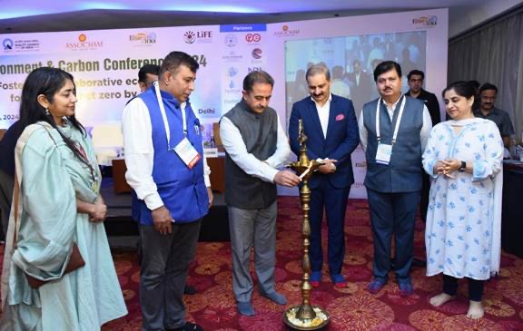Kirtivardhan Singh lighting a ceremonial lamp at a conference