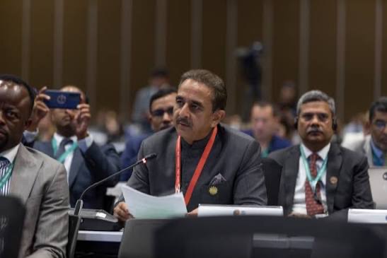 Kirtivardhan Singh reading notes at a conference desk