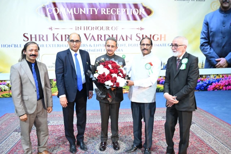 Kirtivardhan Singh holding a bouquet at a community reception